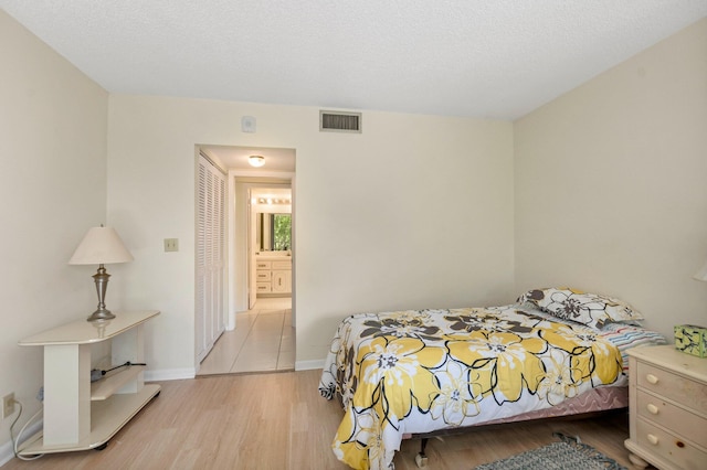 bedroom featuring wood finished floors and baseboards