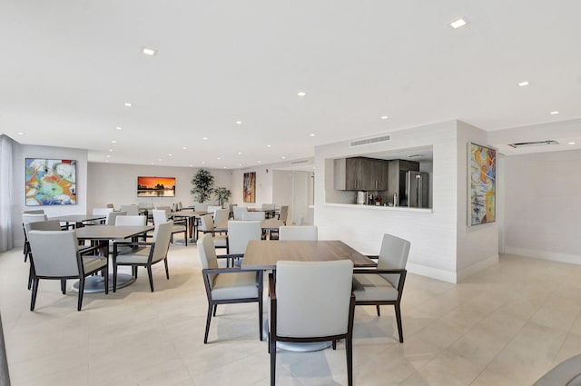 dining space featuring light tile patterned floors and recessed lighting