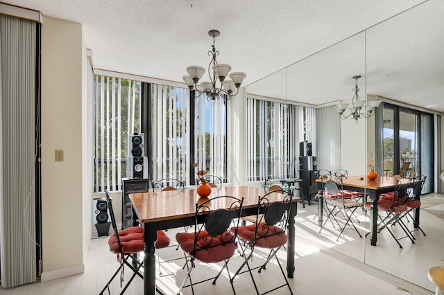 dining space featuring a chandelier, floor to ceiling windows, a textured ceiling, and light wood finished floors