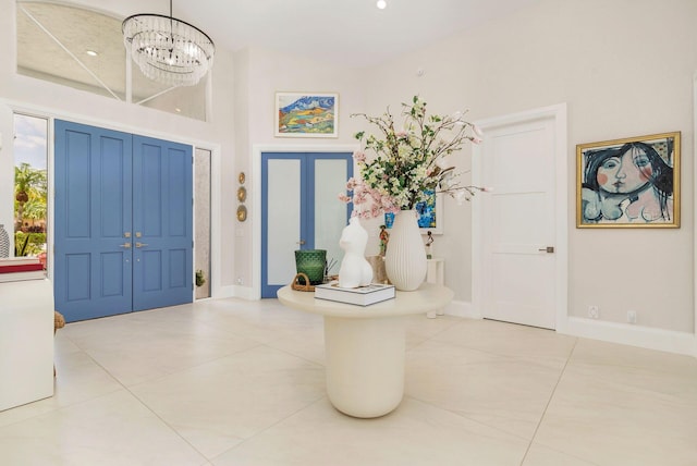 8270 Bob O Link Dr, West Palm Beach, FL 33412 - entryway featuring a chandelier, tile patterned flooring, baseboards, and a towering ceiling