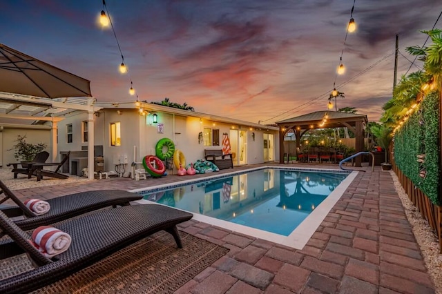 1445 Cindy Dr, Lake Worth Beach, FL 33461 - pool at dusk with a patio area, a gazebo, and an outdoor pool