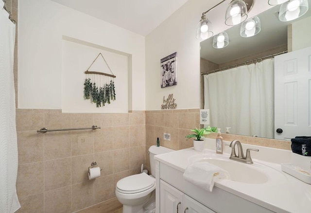 1445 Cindy Dr, Lake Worth Beach, FL 33461 - bathroom with toilet, tile walls, vanity, and wainscoting