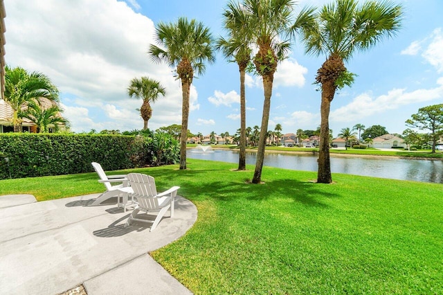 12811 Oak Knoll Dr, Palm Beach Gardens, FL 33418 - view of green lawn with a water view and a patio area