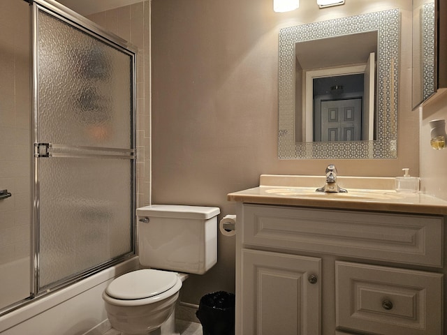full bathroom with vanity, toilet, and combined bath / shower with glass door