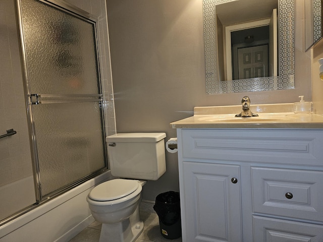 bathroom with vanity, toilet, enclosed tub / shower combo, and tile patterned flooring