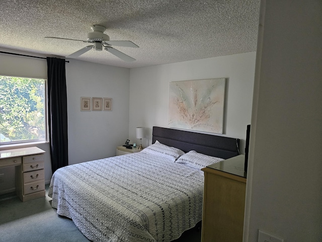 carpeted bedroom with a textured ceiling and ceiling fan