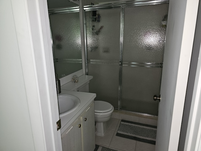 full bathroom with a stall shower, tile patterned floors, vanity, and toilet