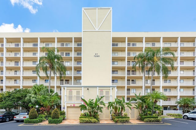 7290 Kinghurst Dr Unit 607, Delray Beach, FL 33446 - view of apartment building / complex featuring uncovered parking