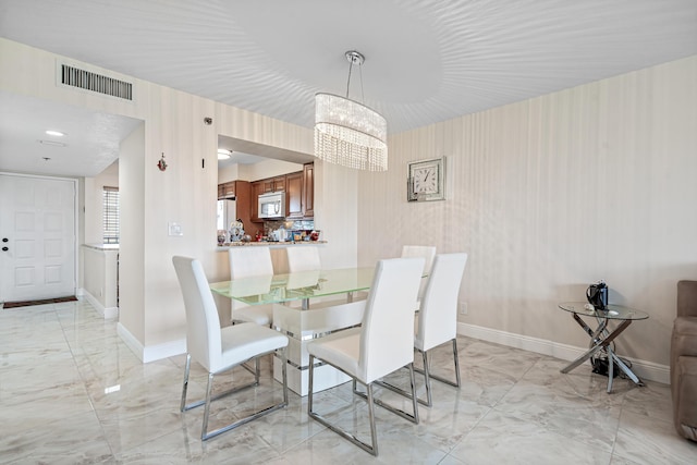 7290 Kinghurst Dr Unit 607, Delray Beach, FL 33446 - dining area with light marble finish floors and a chandelier