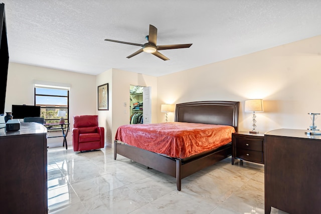 7290 Kinghurst Dr Unit 607, Delray Beach, FL 33446 - bedroom featuring a spacious closet, a ceiling fan, a closet, and a textured ceiling