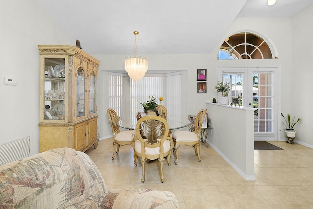 3204 SE Otis Ln, Port Saint Lucie, FL 34984 - dining space featuring a chandelier, baseboards, light tile patterned floors, and lofted ceiling