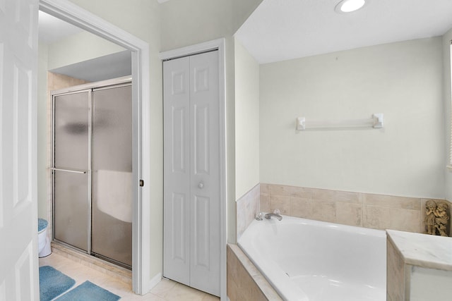 3204 SE Otis Ln, Port Saint Lucie, FL 34984 - bathroom with a closet, a bath, a stall shower, and tile patterned flooring