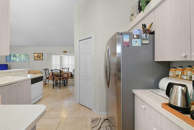 3204 SE Otis Ln, Port Saint Lucie, FL 34984 - kitchen with white dishwasher, freestanding refrigerator, light countertops, and vaulted ceiling