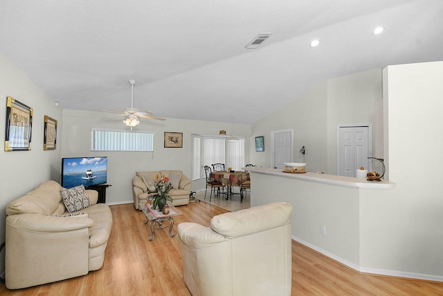 3204 SE Otis Ln, Port Saint Lucie, FL 34984 - living room featuring light wood finished floors, lofted ceiling, a ceiling fan, baseboards, and recessed lighting