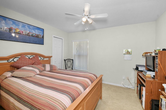 3204 SE Otis Ln, Port Saint Lucie, FL 34984 - bedroom featuring light carpet, baseboards, ceiling fan, and a closet