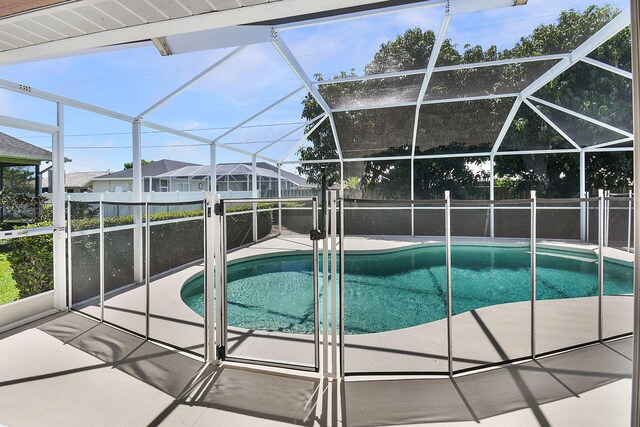 3204 SE Otis Ln, Port Saint Lucie, FL 34984 - view of swimming pool featuring a patio area and glass enclosure