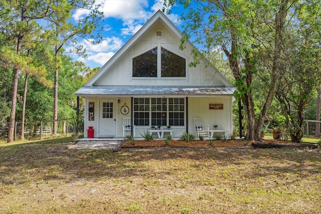 12389 186th St N, Jupiter, FL 33478 - view of front of property with covered porch, board and batten siding, and metal roof