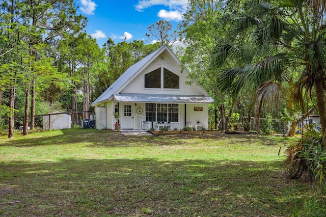 12389 186th St N, Jupiter, FL 33478 - back of house featuring a yard, a porch, and metal roof