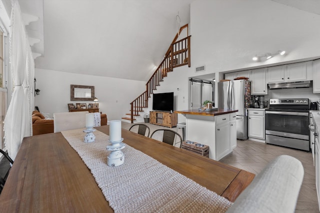 12389 186th St N, Jupiter, FL 33478 - dining space featuring stairway and high vaulted ceiling