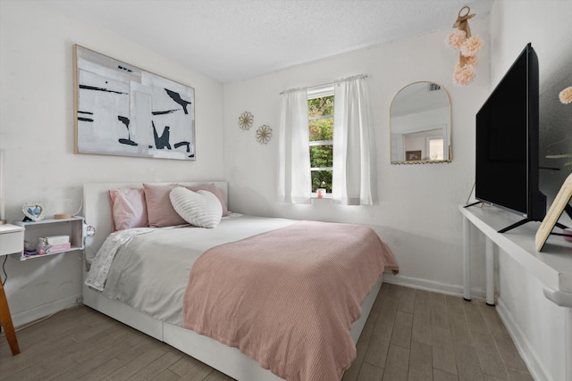 12389 186th St N, Jupiter, FL 33478 - bedroom with wood finished floors, baseboards, and a textured ceiling