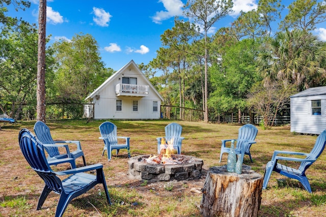 12389 186th St N, Jupiter, FL 33478 - view of grassy yard with a fire pit, a balcony, and an outdoor structure
