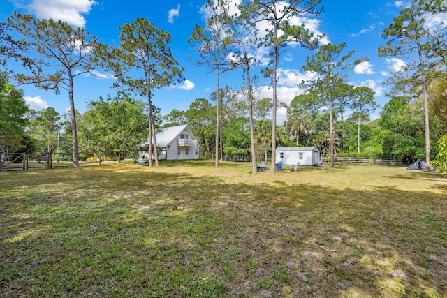 12389 186th St N, Jupiter, FL 33478 - view of yard with an outdoor structure, view of wooded area, and a storage unit