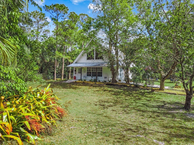 12389 186th St N, Jupiter, FL 33478 - view of grassy yard featuring a porch