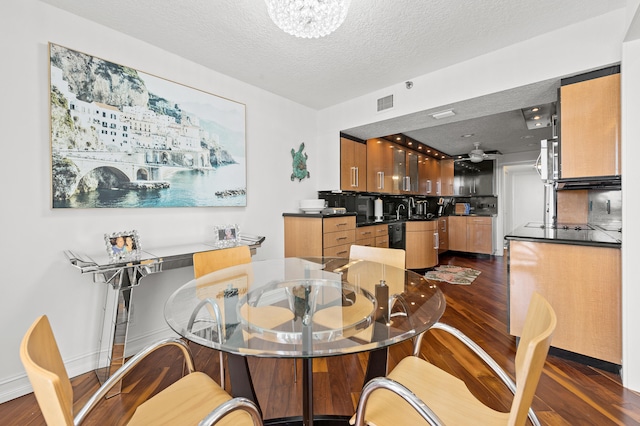 901 E Camino Real Unit 5C, Boca Raton, FL 33432 - dining area featuring dark wood-style flooring, a textured ceiling, and a chandelier