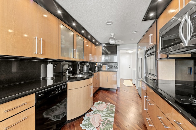 901 E Camino Real Unit 5C, Boca Raton, FL 33432 - kitchen featuring black appliances, a sink, tasteful backsplash, dark wood-type flooring, and a textured ceiling