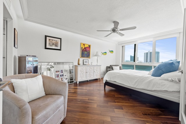 901 E Camino Real Unit 5C, Boca Raton, FL 33432 - bedroom featuring a textured ceiling, crown molding, wood finished floors, and a ceiling fan