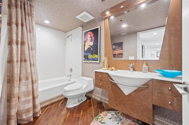 901 E Camino Real Unit 5C, Boca Raton, FL 33432 - bathroom featuring toilet, wood finished floors, recessed lighting, vanity, and shower / bath combo with shower curtain