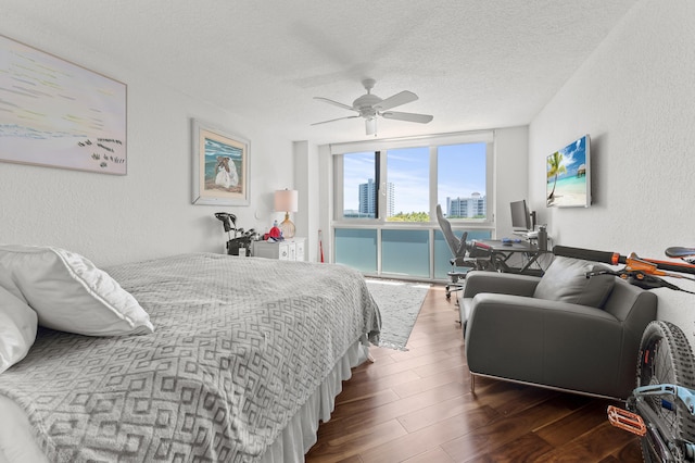 901 E Camino Real Unit 5C, Boca Raton, FL 33432 - bedroom featuring a textured wall, wood finished floors, a textured ceiling, expansive windows, and access to outside