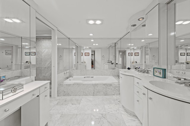 901 E Camino Real Unit 5C, Boca Raton, FL 33432 - bathroom with a garden tub, recessed lighting, vanity, and marble finish floors