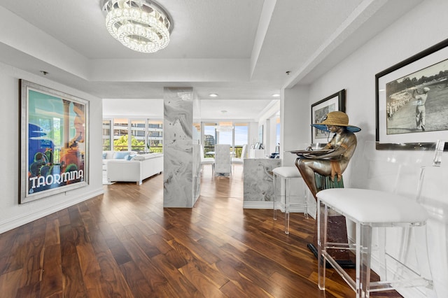 901 E Camino Real Unit 5C, Boca Raton, FL 33432 - hall with wood-type flooring, a chandelier, and baseboards