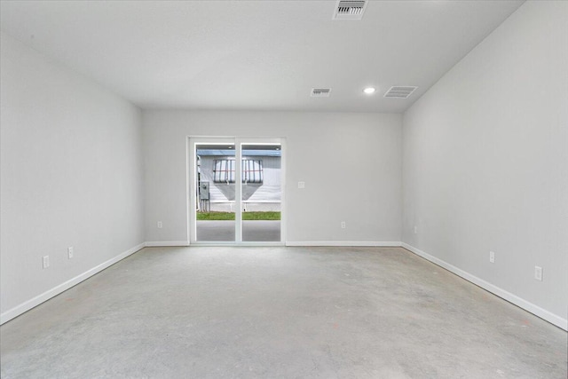 unfurnished room with concrete floors, baseboards, and recessed lighting