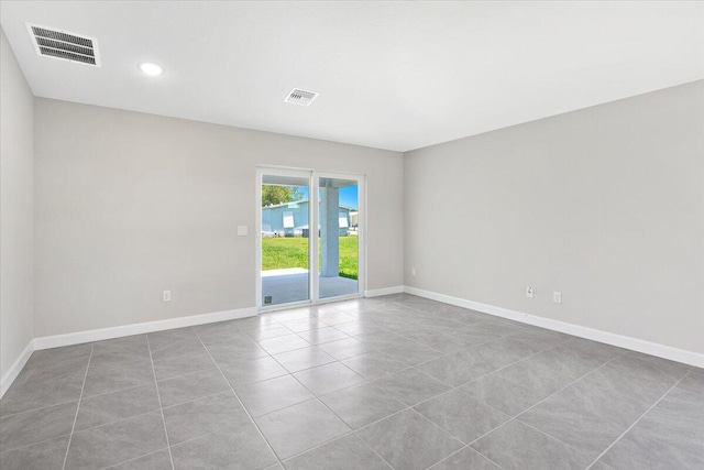 15 Jacaranda Ln, Port Saint Lucie, FL 34952 - tiled empty room featuring baseboards and recessed lighting