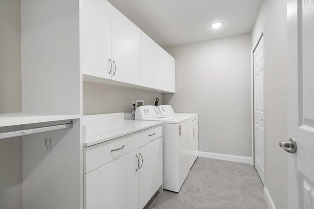 15 Jacaranda Ln, Port Saint Lucie, FL 34952 - laundry area with washer and clothes dryer, cabinet space, baseboards, recessed lighting, and light tile patterned floors