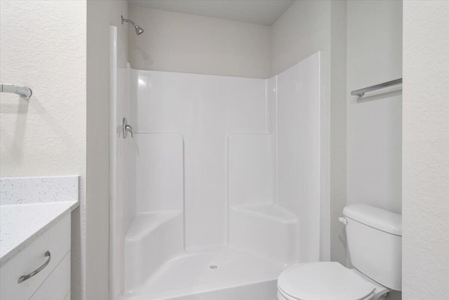15 Jacaranda Ln, Port Saint Lucie, FL 34952 - full bath featuring toilet, vanity, a shower, and a textured wall