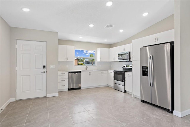 15 Jacaranda Ln, Port Saint Lucie, FL 34952 - kitchen featuring stainless steel appliances, a sink, light countertops, white cabinetry, and baseboards