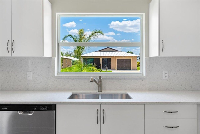 15 Jacaranda Ln, Port Saint Lucie, FL 34952 - kitchen with dishwasher, a sink, white cabinets, and tasteful backsplash