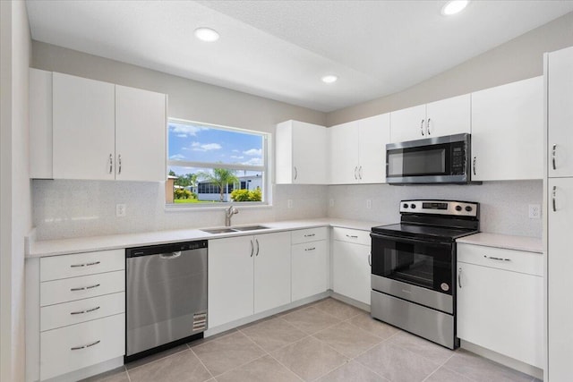 15 Jacaranda Ln, Port Saint Lucie, FL 34952 - kitchen with appliances with stainless steel finishes, a sink, light countertops, decorative backsplash, and recessed lighting