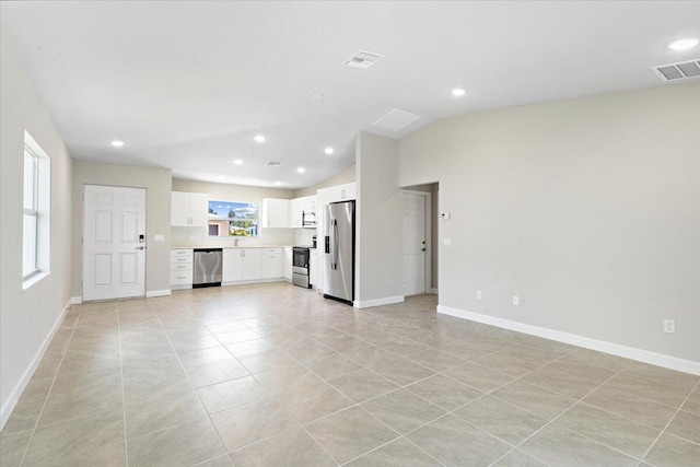 15 Jacaranda Ln, Port Saint Lucie, FL 34952 - unfurnished living room featuring light tile patterned floors, lofted ceiling, baseboards, and recessed lighting