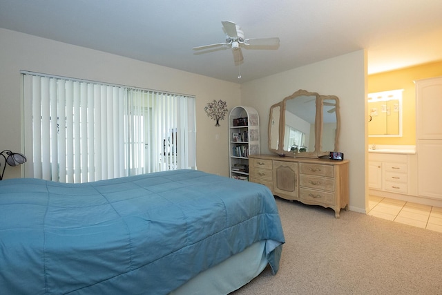 915 Savannas Point Dr Unit E, Fort Pierce, FL 34950 - bedroom with light carpet, ensuite bathroom, ceiling fan, and light tile patterned flooring
