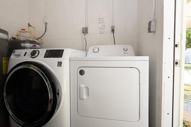 915 Savannas Point Dr Unit E, Fort Pierce, FL 34950 - laundry area with washer and clothes dryer, concrete block wall, and water heater