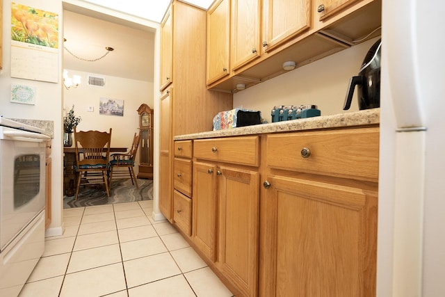 915 Savannas Point Dr Unit E, Fort Pierce, FL 34950 - kitchen featuring light tile patterned flooring, light countertops, and electric range oven