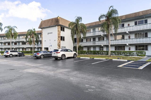 view of apartment building / complex with uncovered parking