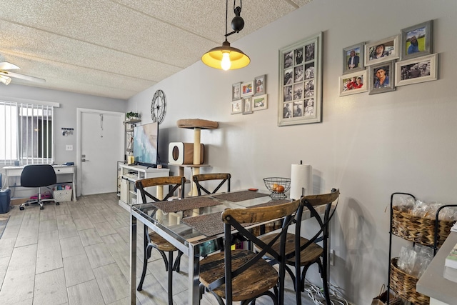 dining area with a textured ceiling and a desk