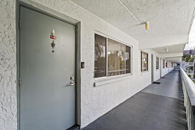 doorway to property with stucco siding