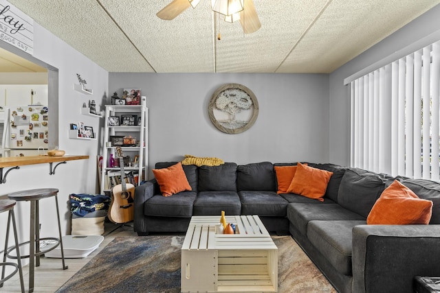 living room with ceiling fan and wood finished floors