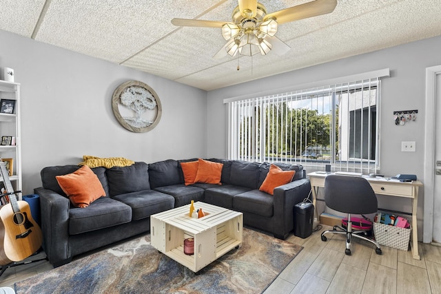 living area featuring a ceiling fan and wood finished floors